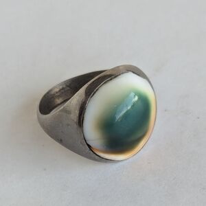 Vintage operculum ring featuring green and orangeish tones on cream, size 10